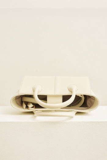 Medium Ivoire leather bag by MIULIN, featuring smooth texture and structured design with dual handles and minimalist style.