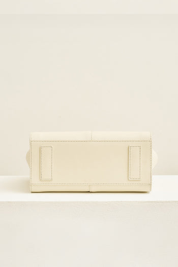 Medium Ivoire leather bag by MIULIN with sturdy handles and sleek design, showing its elegant beige color and smooth texture.