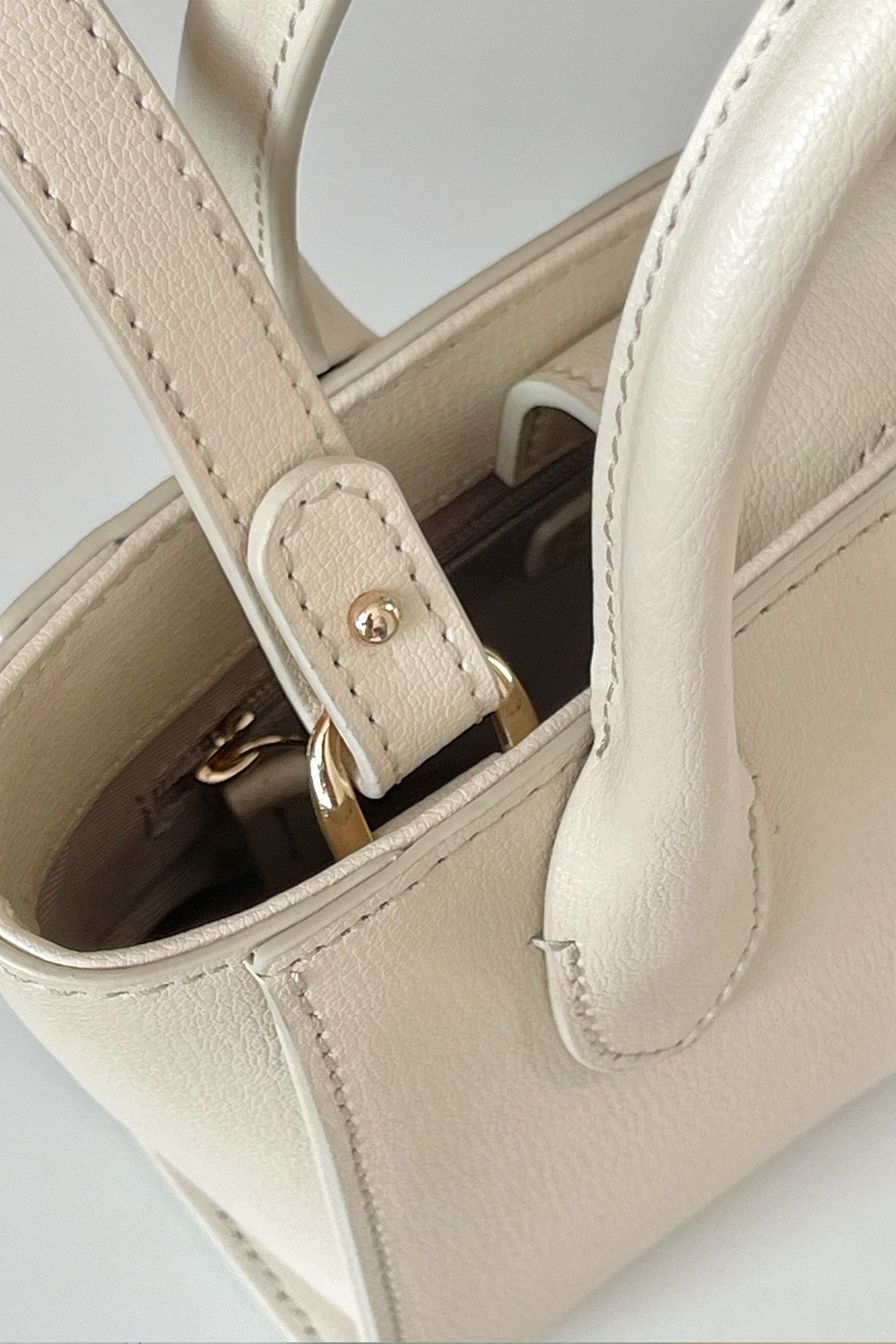 Small Ivoire leather tote bag by MIULIN featuring a sleek design, top handles, and smooth ivory-colored leather.