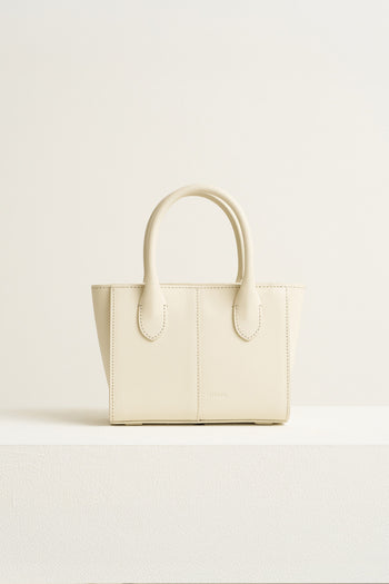 Small Ivoire leather bag by MIULIN featuring a sleek design with top handles and subtle stitching.