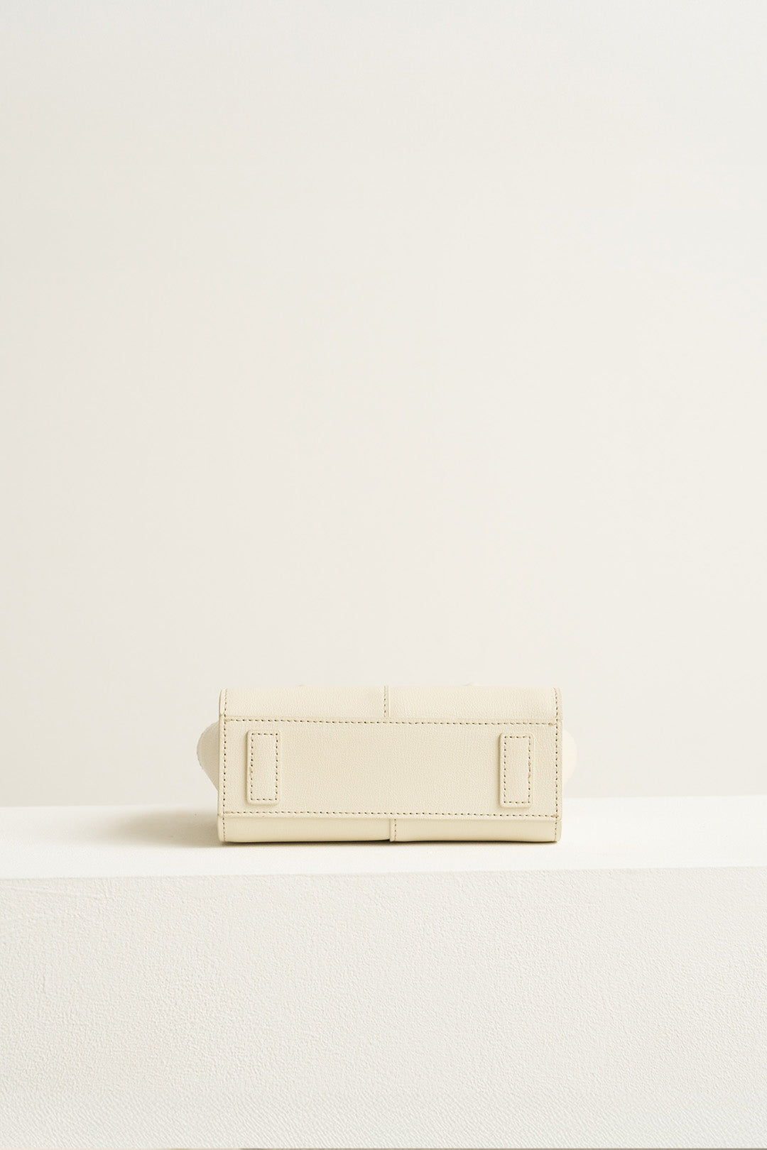 Small Ivoire leather tote bag by MIULIN, featuring smooth ivory leather with sturdy handles and minimalist design.
