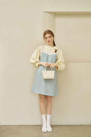 Small ivory leather bag by MIULIN featuring a sleek design and elegant handles.