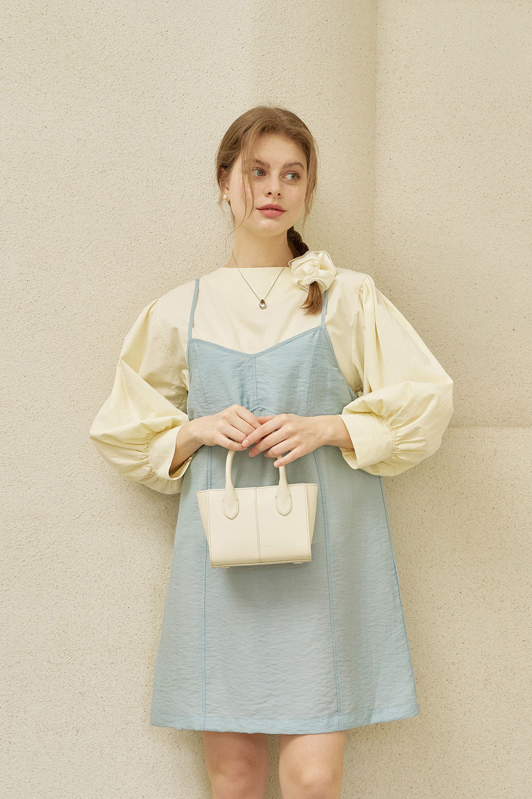 Small Ivoire leather bag by MIULIN featuring a sleek tote design with sturdy handles and smooth leather finish.