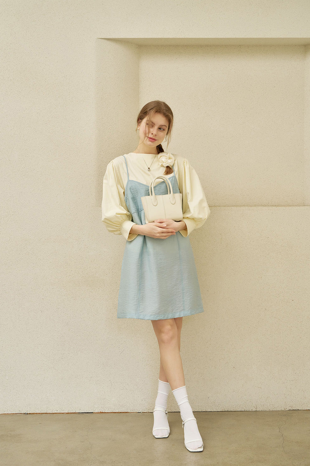 Small Ivoire leather bag by MIULIN featuring a sleek design, top handle, and elegant ivory color for stylish everyday use.