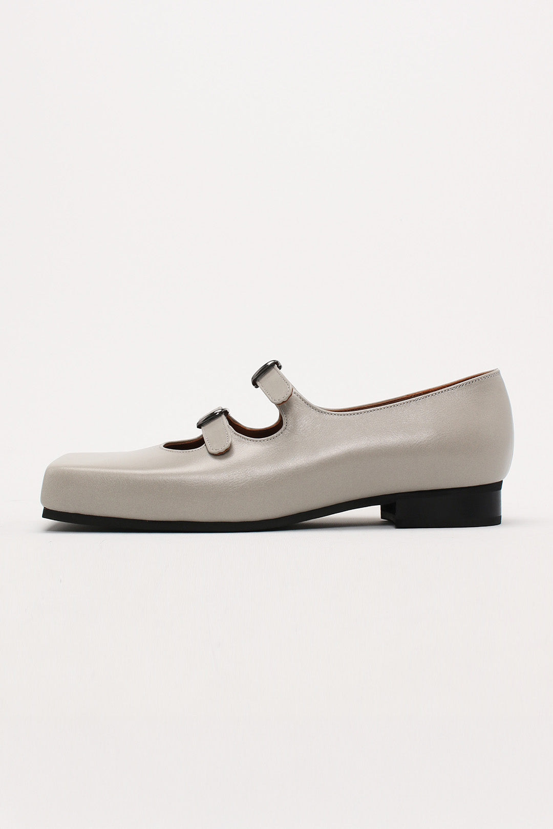 Light gray Nora strap flat shoes by Finoacinque featuring a sleek design and comfortable flat sole.