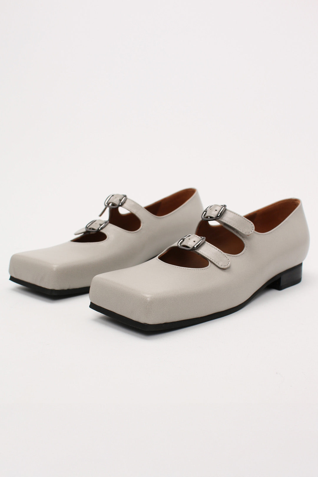 Light gray Nora strap flat shoes by Finoacinque featuring a sleek, minimalist design and comfortable flat sole.