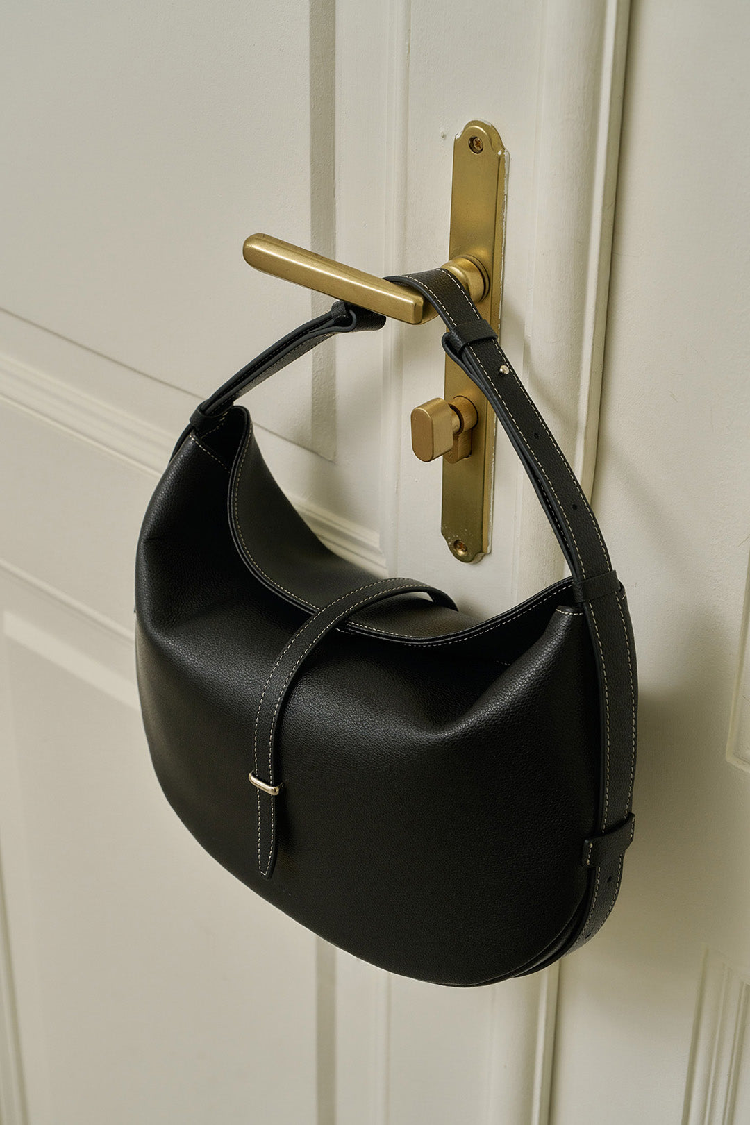 Black MIULIN Shellie Hobo Bag with soft leather and slouchy design, featuring a shoulder strap and minimalist style.