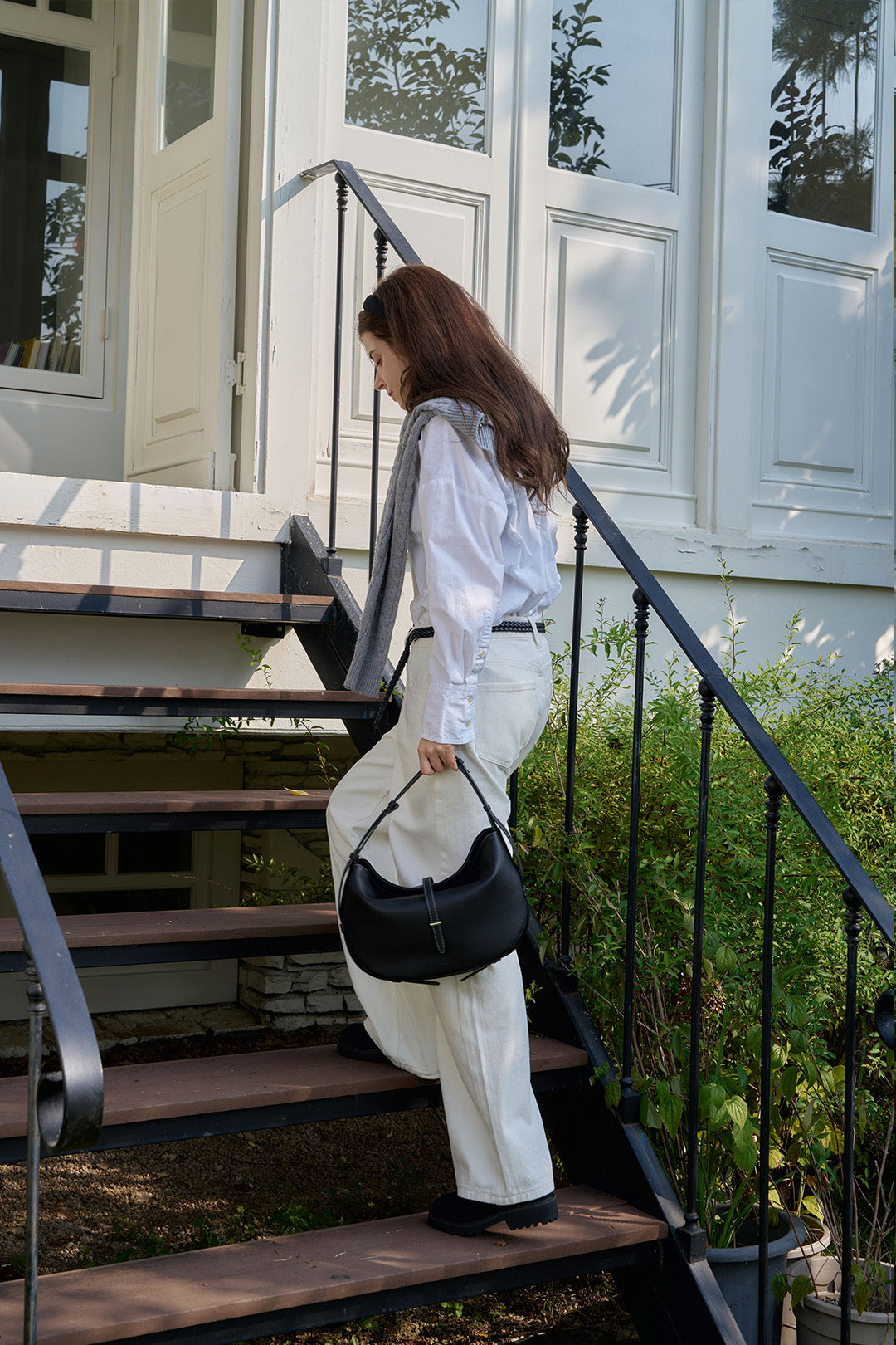 Black MIULIN Shellie Hobo Bag with adjustable strap and spacious interior, shown from side view.