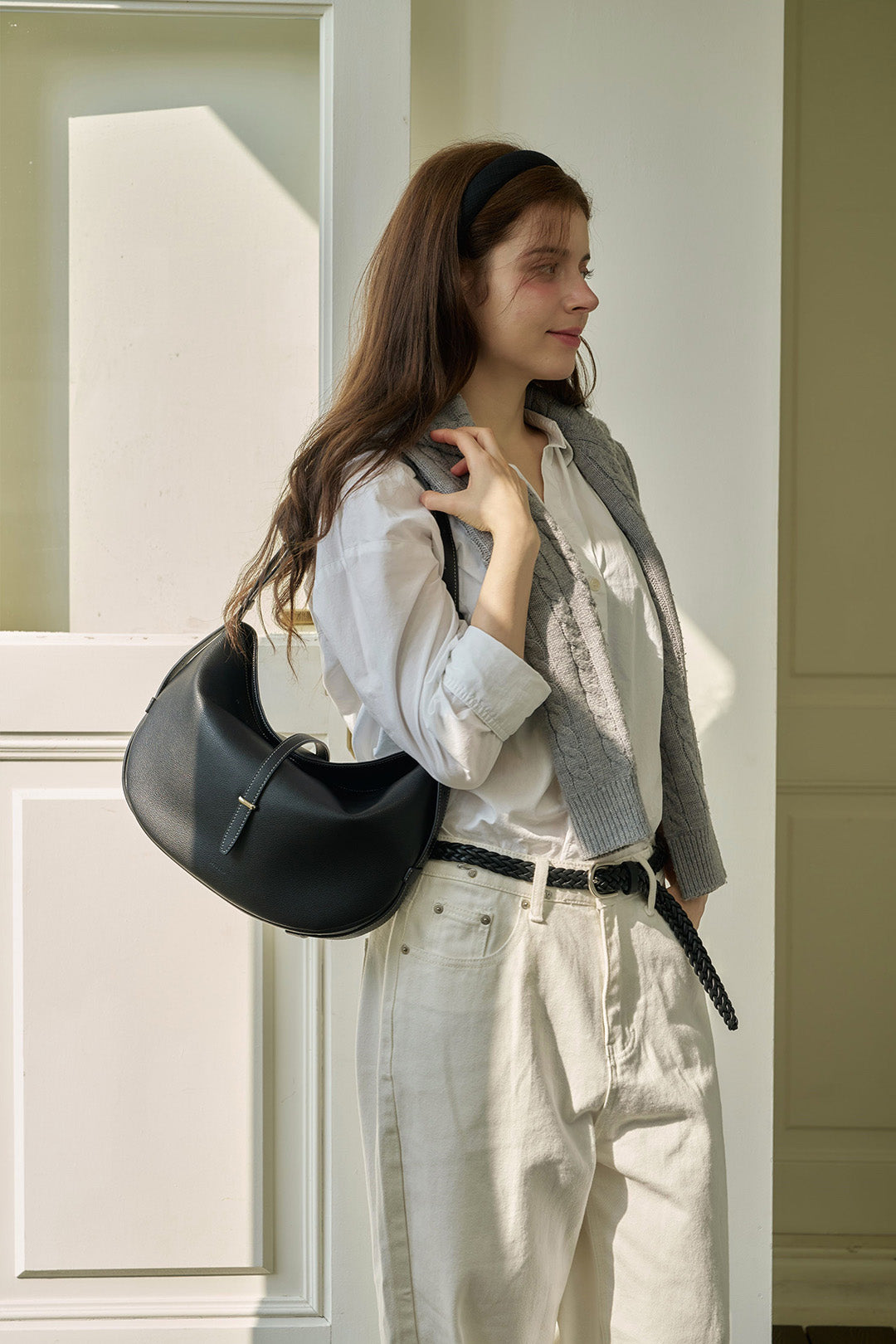 Black Shellie Hobo Bag by MIULIN showing its sleek design, soft leather material, and spacious interior.