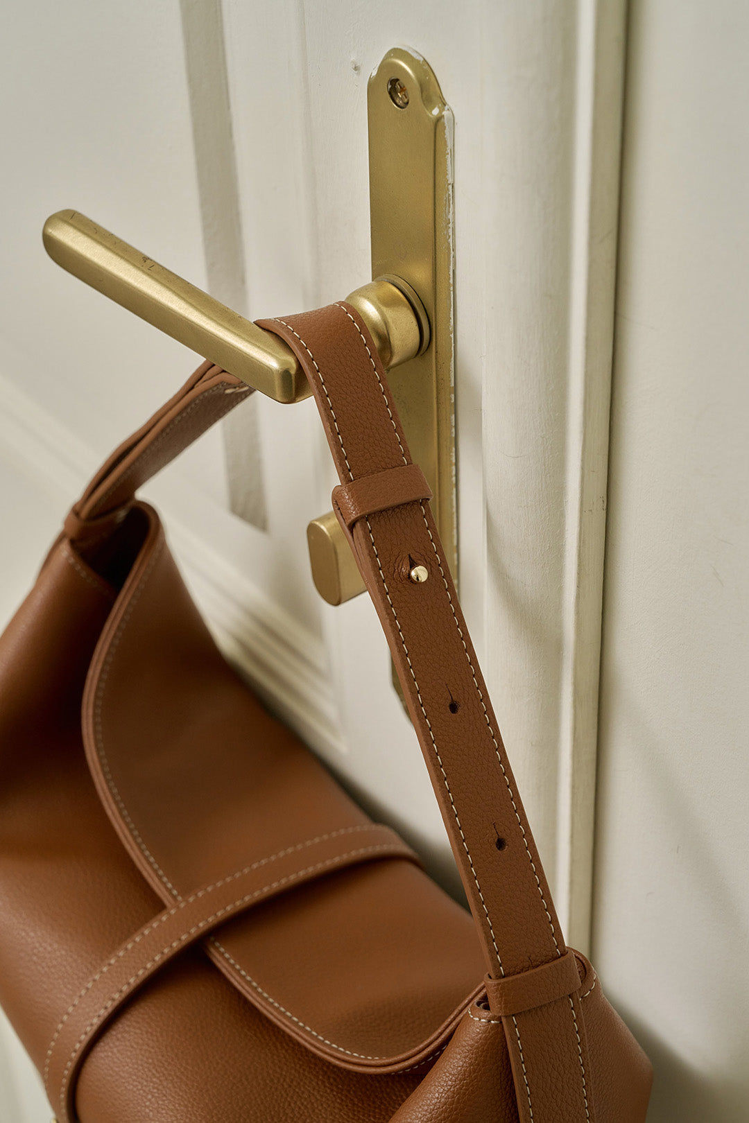 MIULIN Shellie Hobo Bag in camel leather, featuring a slouchy design and adjustable shoulder strap, on a neutral background.