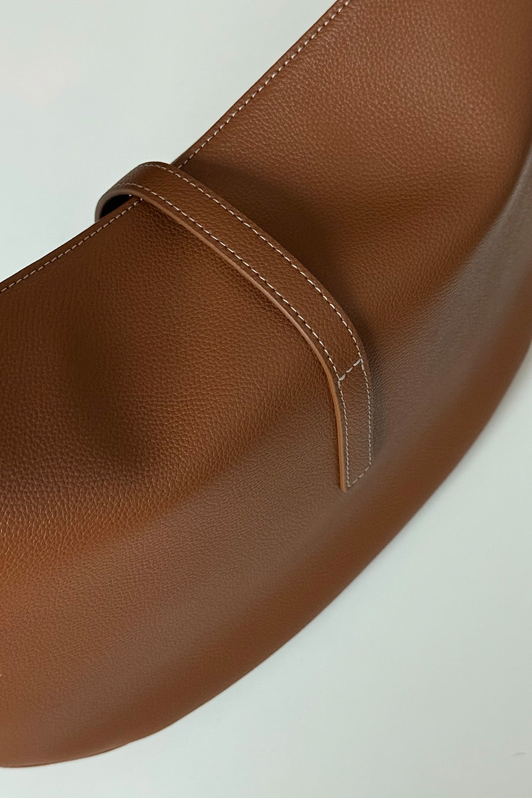 MIULIN Shellie Hobo Bag in camel leather, showing its soft, slouchy design with a shoulder strap and subtle stitching details.