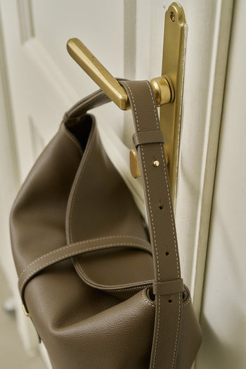MIULIN Shellie Hobo Bag in Etoupe color with rounded shape, soft leather, and adjustable strap, displayed on a neutral background.