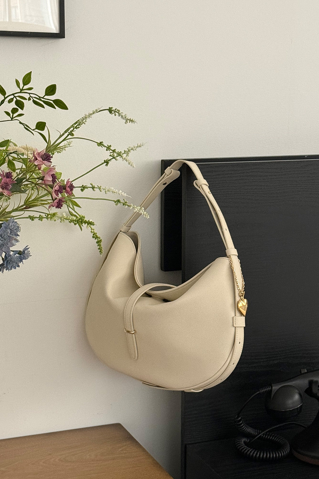 Ivory Shellie Hobo Bag by MIULIN featuring a soft leather design and adjustable shoulder strap.
