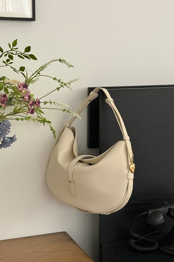 Ivory Shellie Hobo Bag by MIULIN featuring a soft leather design and adjustable shoulder strap.