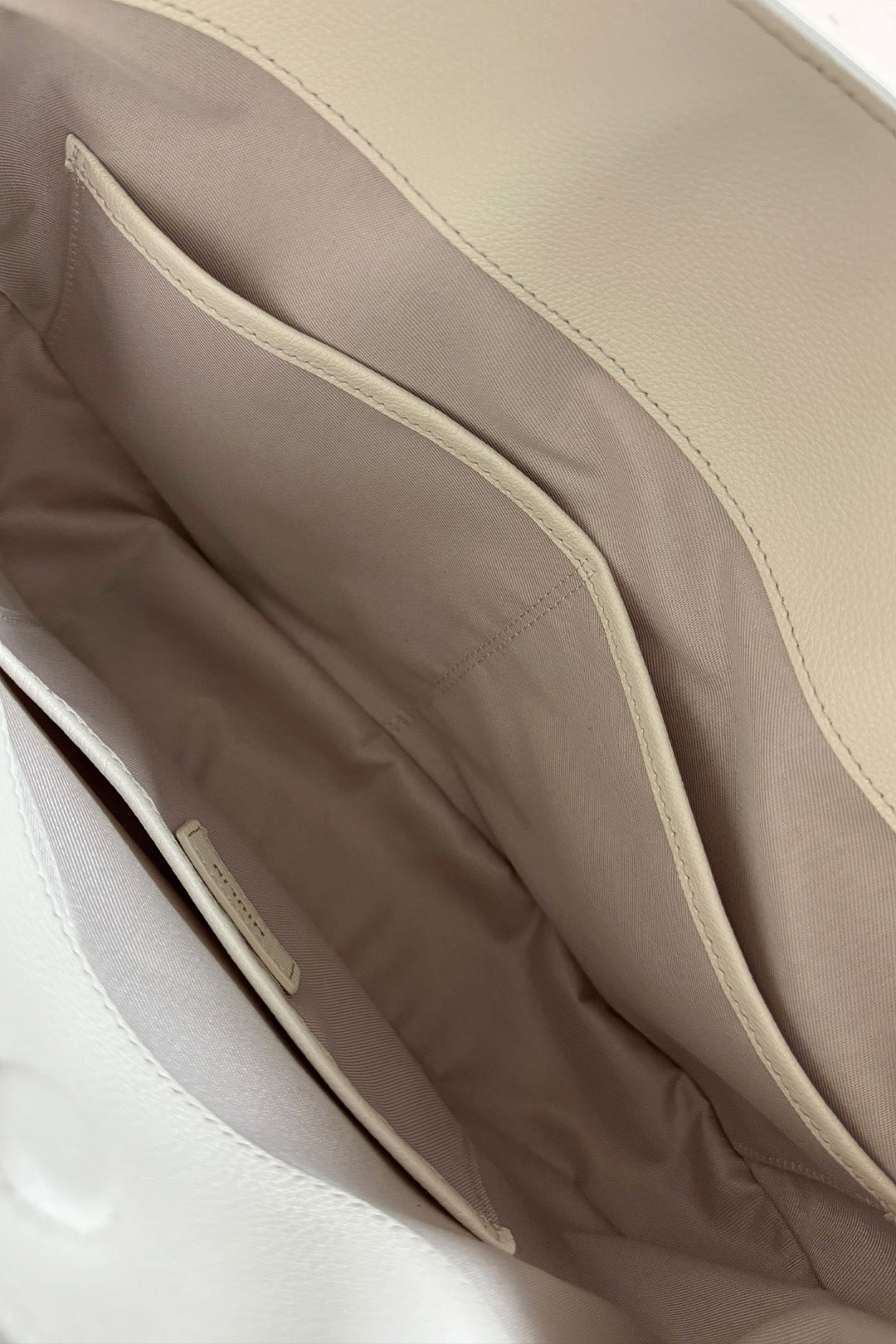 Ivory MIULIN Shellie Hobo Bag with rounded shape and shoulder strap, featuring soft textured material and minimalist design.