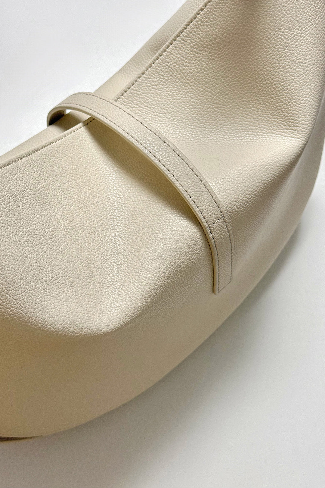 Ivory Shellie Hobo Bag by MIULIN with soft leather, slouchy design, and shoulder strap, displayed on a neutral background