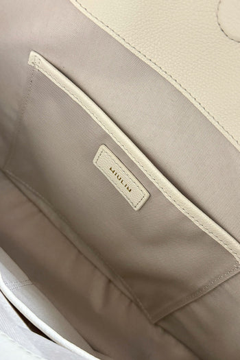 Ivory Shellie Hobo Bag by MIULIN, showcasing soft leather with a slouchy, casual design and top handles for everyday style.