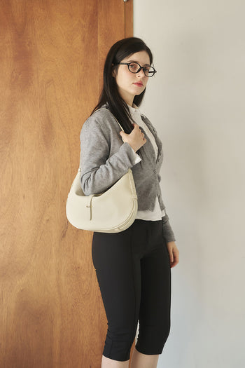 Ivory Shellie Hobo Bag by MIULIN showing its soft leather texture and slouchy hobo style with shoulder strap.