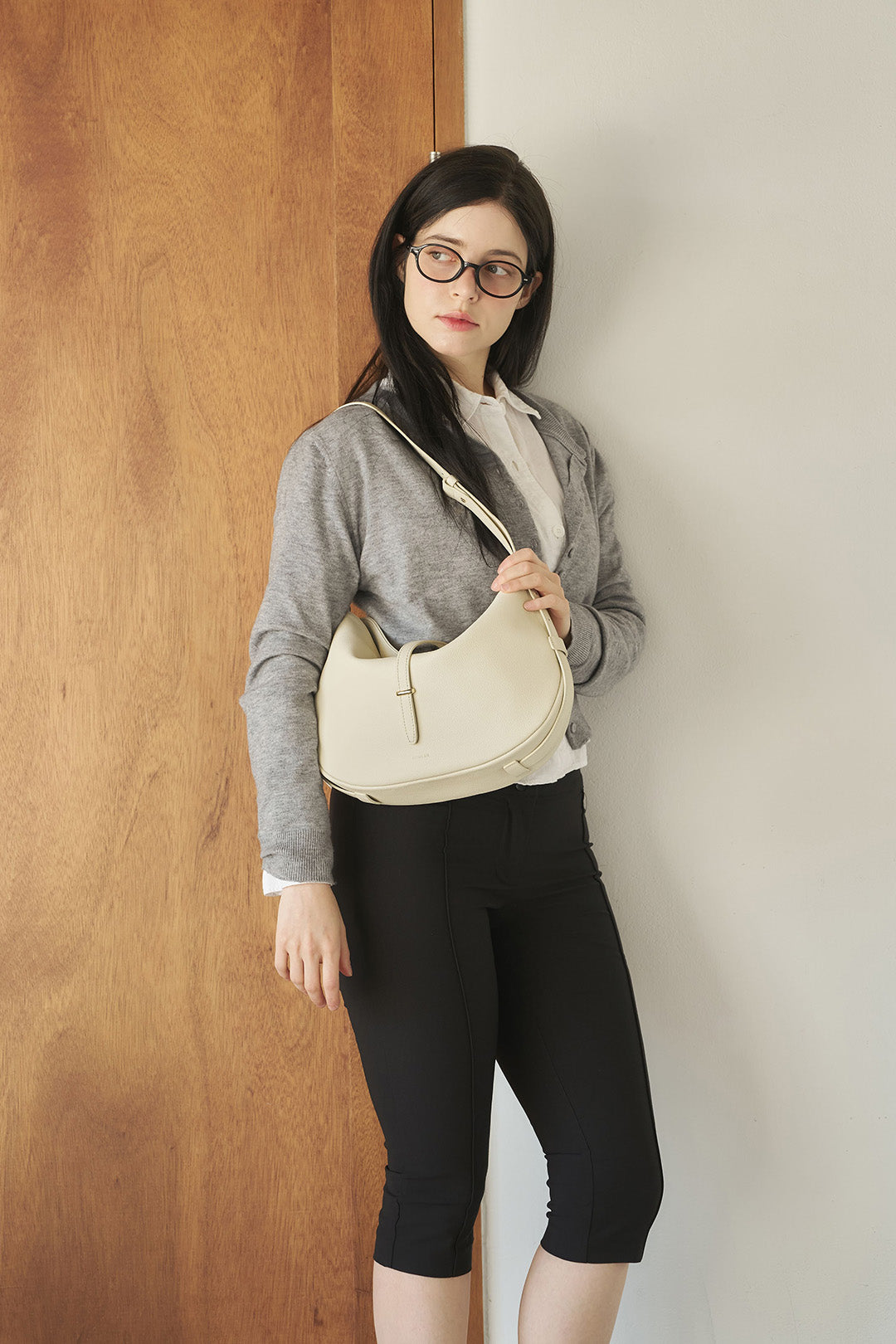 Ivory Shellie Hobo Bag by MIULIN, showcasing a stylish, soft leather bag with a slouchy hobo design and subtle branding details.