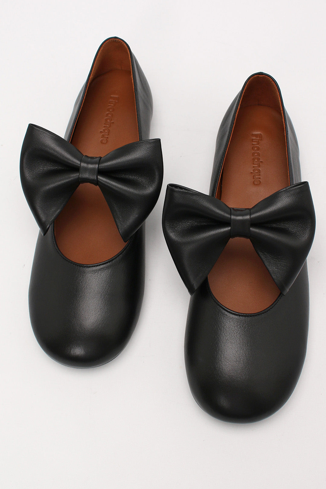 Black Soo Bow Mary Jane flat shoes by Finoacinque featuring a classic design with a bow detail and comfortable slip-on style.