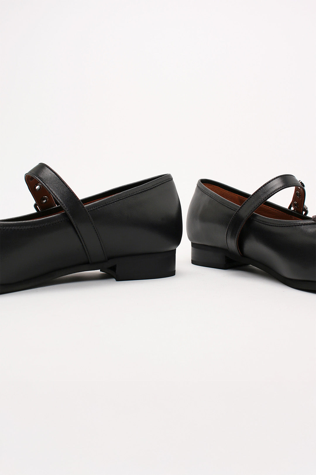 Black Tina Strap Flat Shoes by Finoacinque featuring a sleek design and comfortable flat sole, shown from a side view.