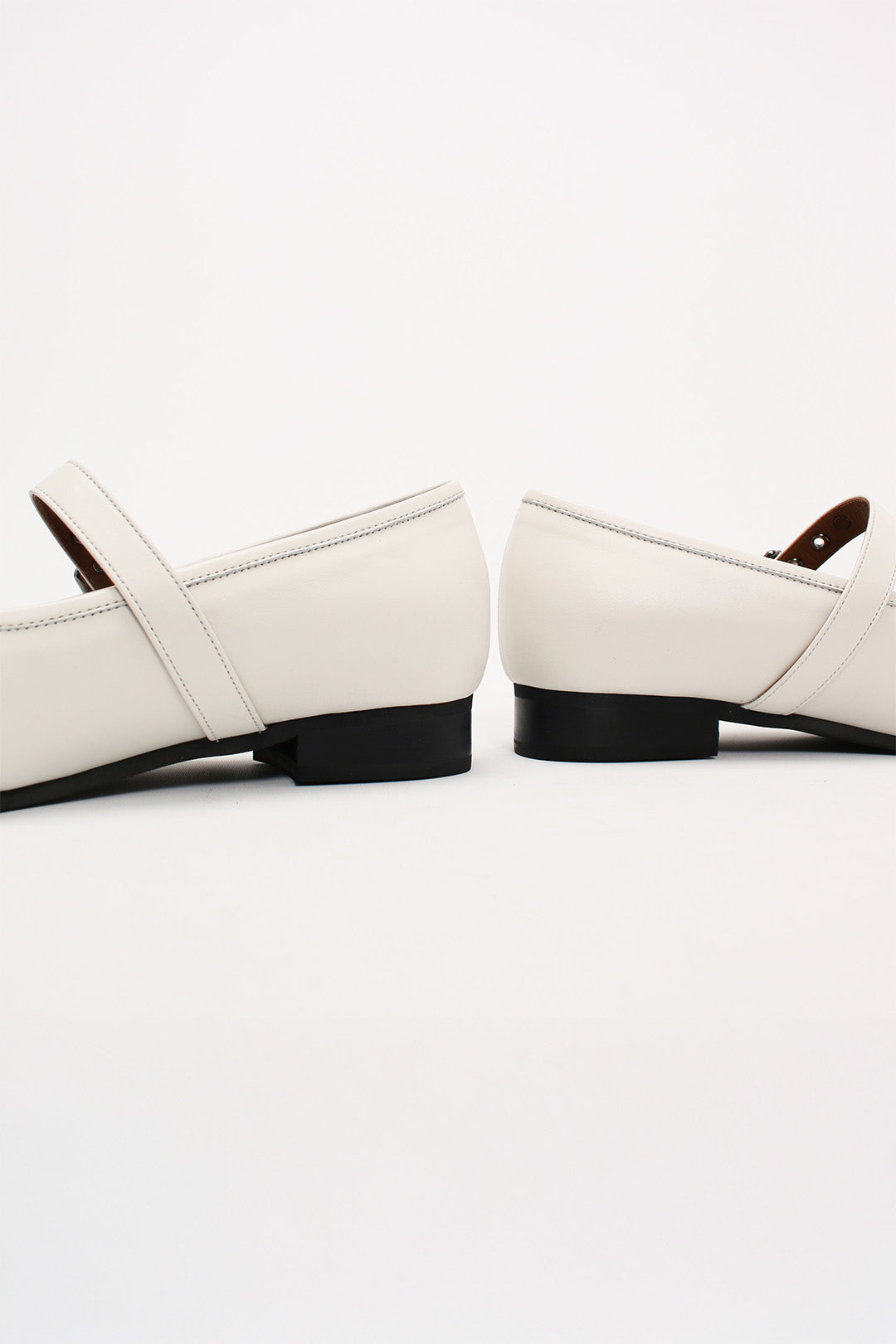 Ivory Tina Strap Flat Shoes by Finoacinque with ankle straps and a sleek, minimalist design for casual or dressy occasions.