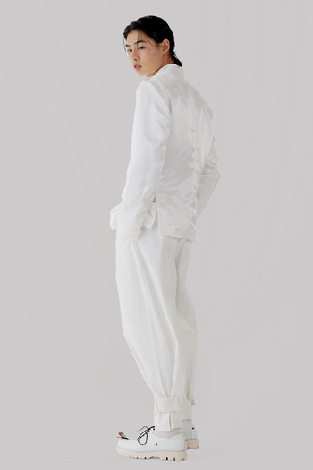 White Peach Balloon Double Wide Trousers by Ahhorn, featuring a loose fit and wide-leg style, shown on a mannequin.