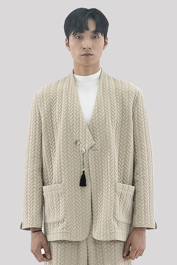 Beige men's twisted overcoat cardigan with traditional short collar by Ahhorn, displayed on a hanger.