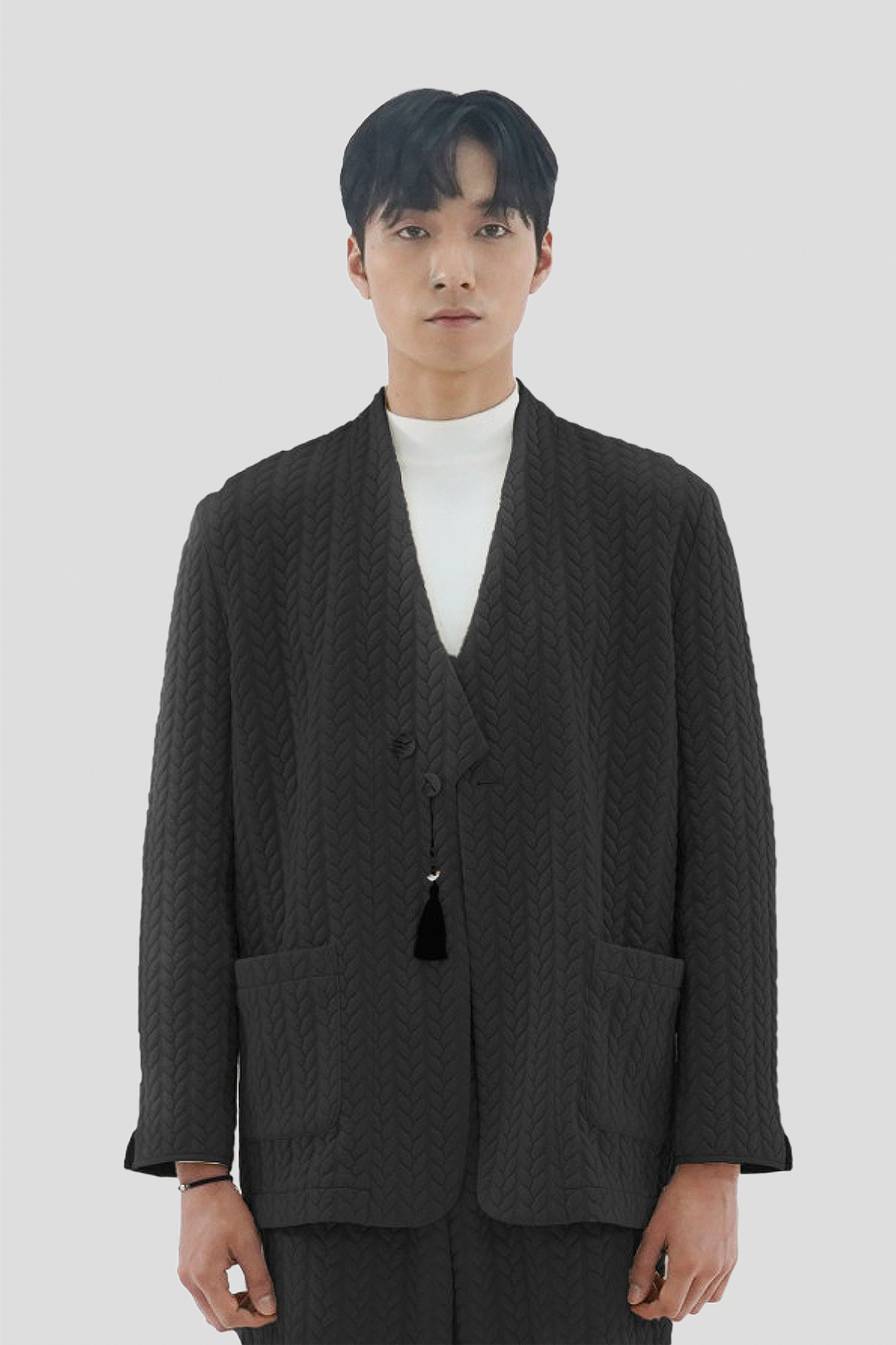 Beige men's twisted overcoat cardigan with traditional short collar by Ahhorn, displayed on a mannequin.