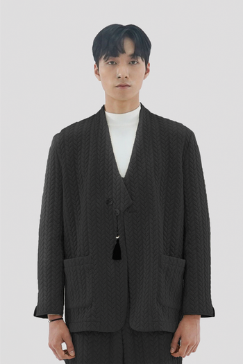Beige men's twisted overcoat cardigan with traditional short collar by Ahhorn, displayed on a mannequin.