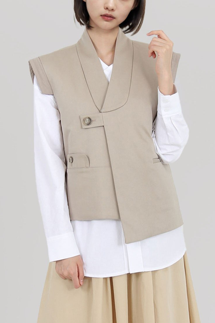 Beige quilted vest with round collar by Ahhorn, stylish sleeveless top perfect for layered fall and winter outfits.
