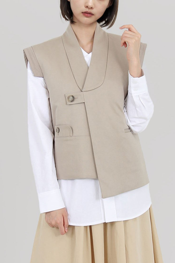 Beige quilted vest with round collar by Ahhorn, stylish sleeveless top perfect for layered fall and winter outfits.