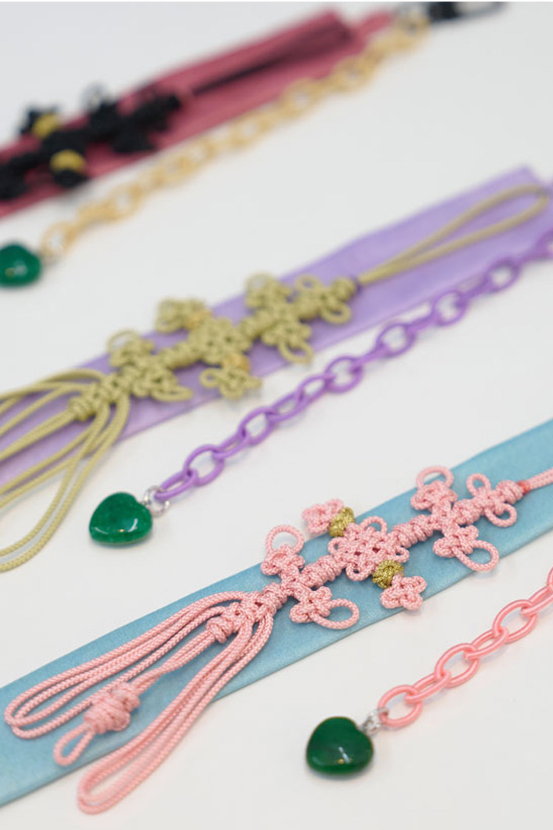 Red beaded knot keychain accessory by CCOMAQUE featuring intricate beadwork and a stylish knot design.