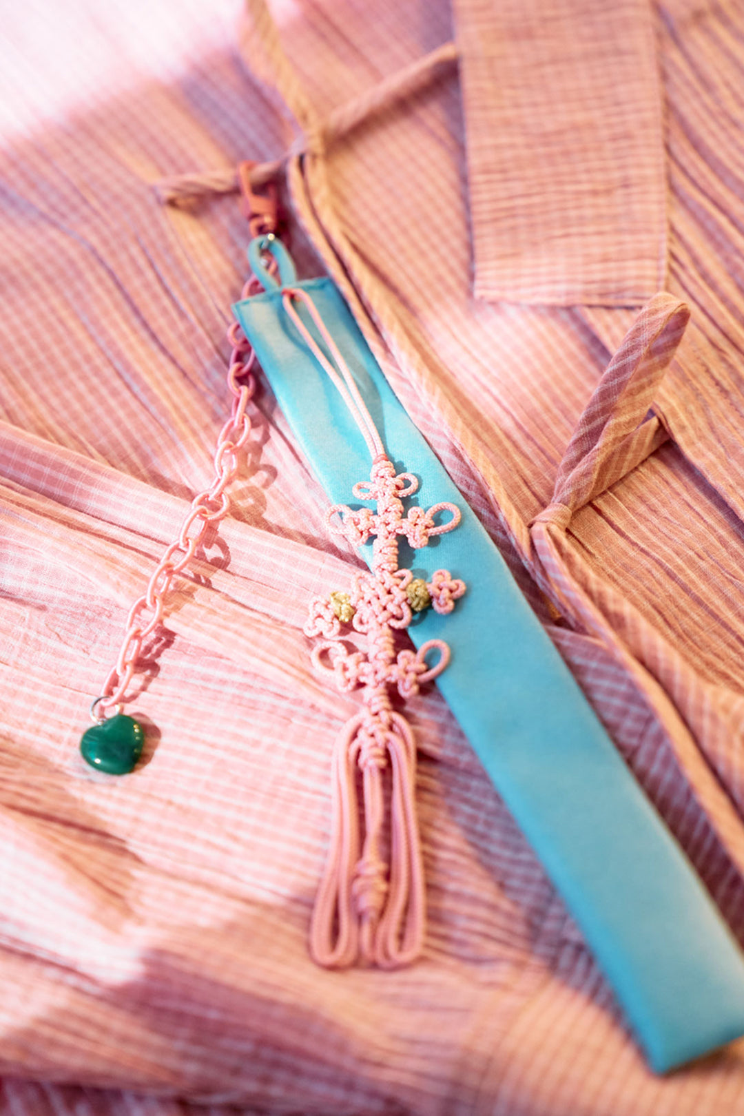 Red beaded knot keychain accessory by CCOMAQUE featuring intricate beaded design and a secure keyring attachment.