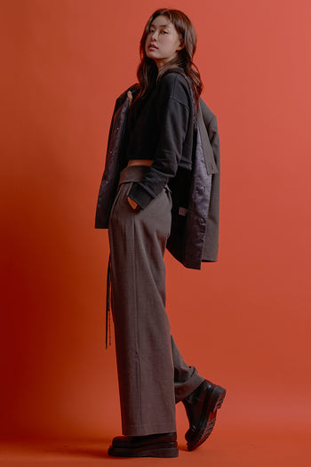 Black CCOMAQUE Four-Panel Wrap Pants, stylish bottoms with a layered design, shown on a model.