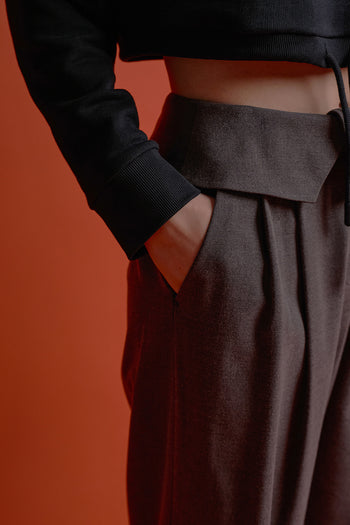 Black CCOMAQUE four-panel wrap pants, stylish bottoms with a layered design, displayed on a model.