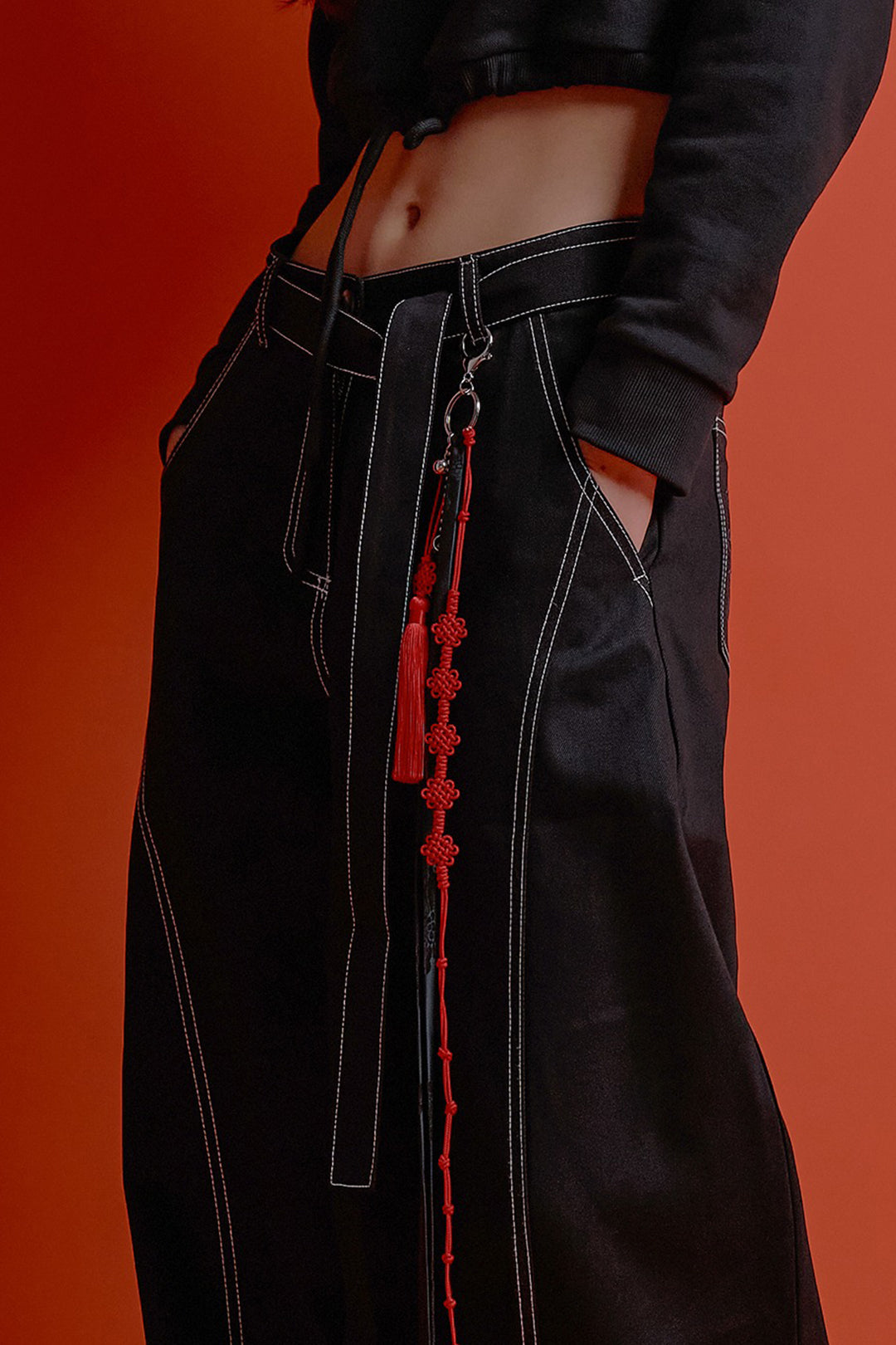 Black CCOMAQUE four-panel wrap pants with a relaxed fit, shown on a model, showcasing stylish and comfortable bottoms.