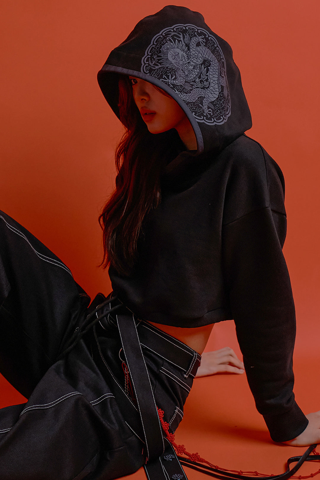Black CCOMAQUE hoodie featuring a detailed dragon emblem on the front, with a comfortable, casual fit.