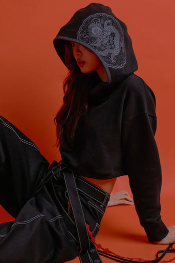 Black CCOMAQUE hoodie featuring a detailed dragon emblem on the front, with a comfortable, casual fit.