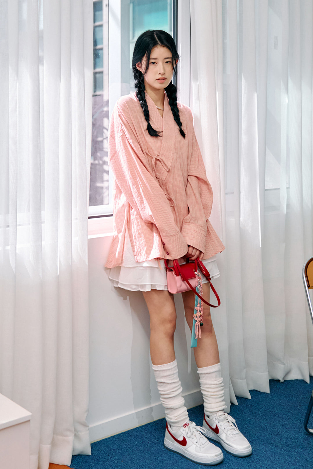 Pink lattice-pattern long Jeogori shirt for women by CCOMAQUE, featuring traditional Korean design and relaxed fit.
