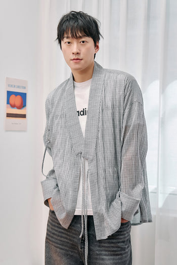 White lattice-pattern long Jeogori shirt for men by CCOMAQUE, featuring traditional design with long sleeves and a relaxed fit.