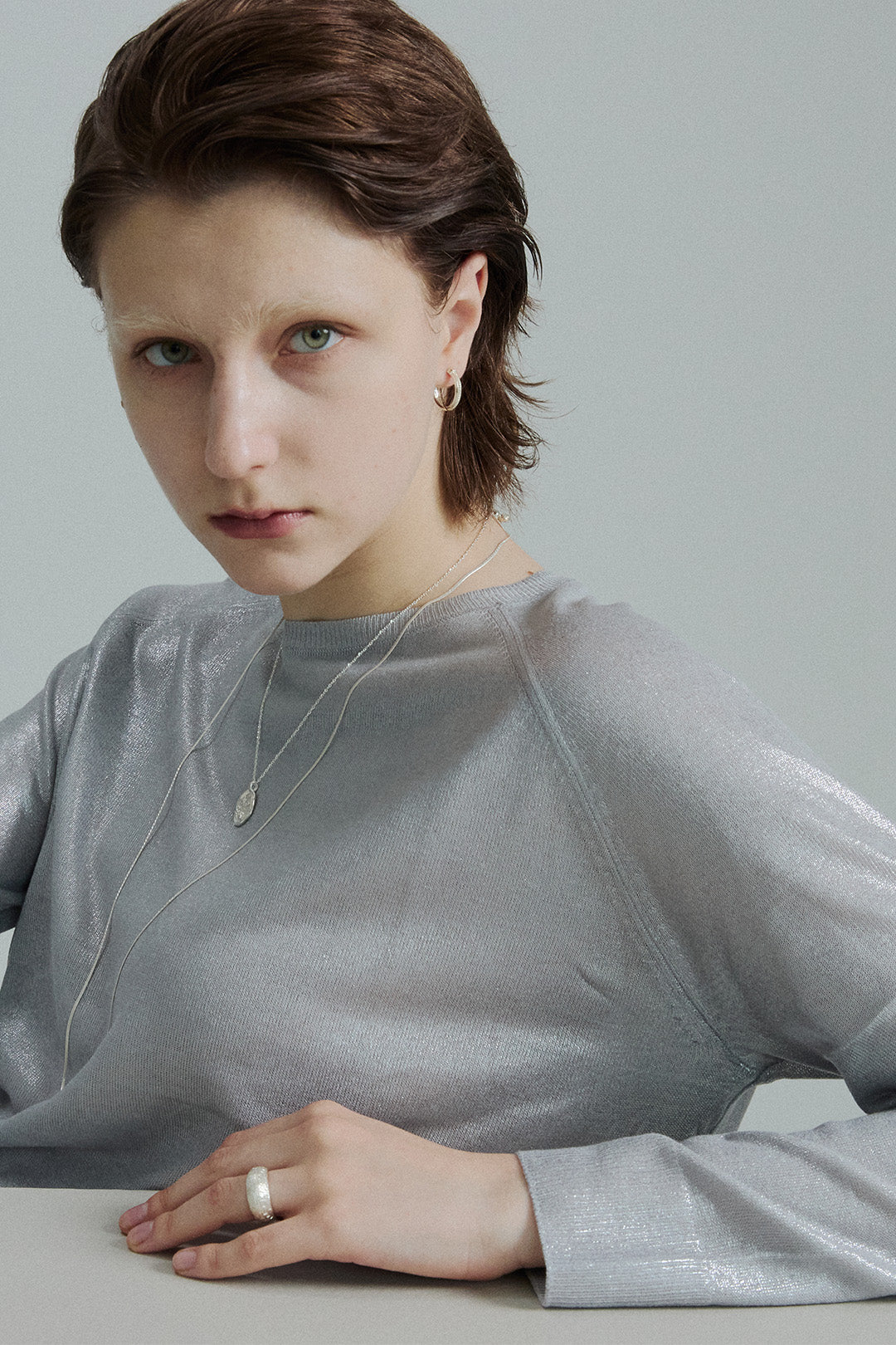 Silver classic earring by Chambriller featuring a simple, elegant design, shown on a plain background.