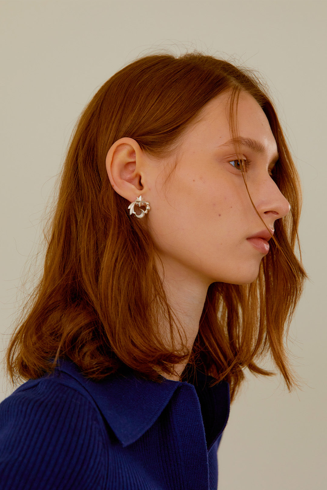 Chambriller Cosmos silver earring featuring a delicate, open hoop design with intricate detailing on a clean background.