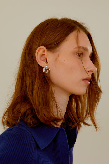 Chambriller Cosmos silver earring featuring a delicate, open hoop design with intricate detailing on a clean background.