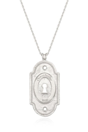Silver lock pendant necklace by Chambriller featuring a sleek design, worn on a chain with a shiny silver finish.