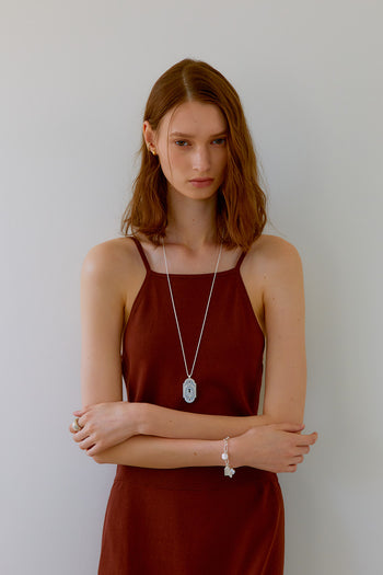 Silver lock pendant necklace by Chambriller featuring a sleek, modern design on a delicate chain.