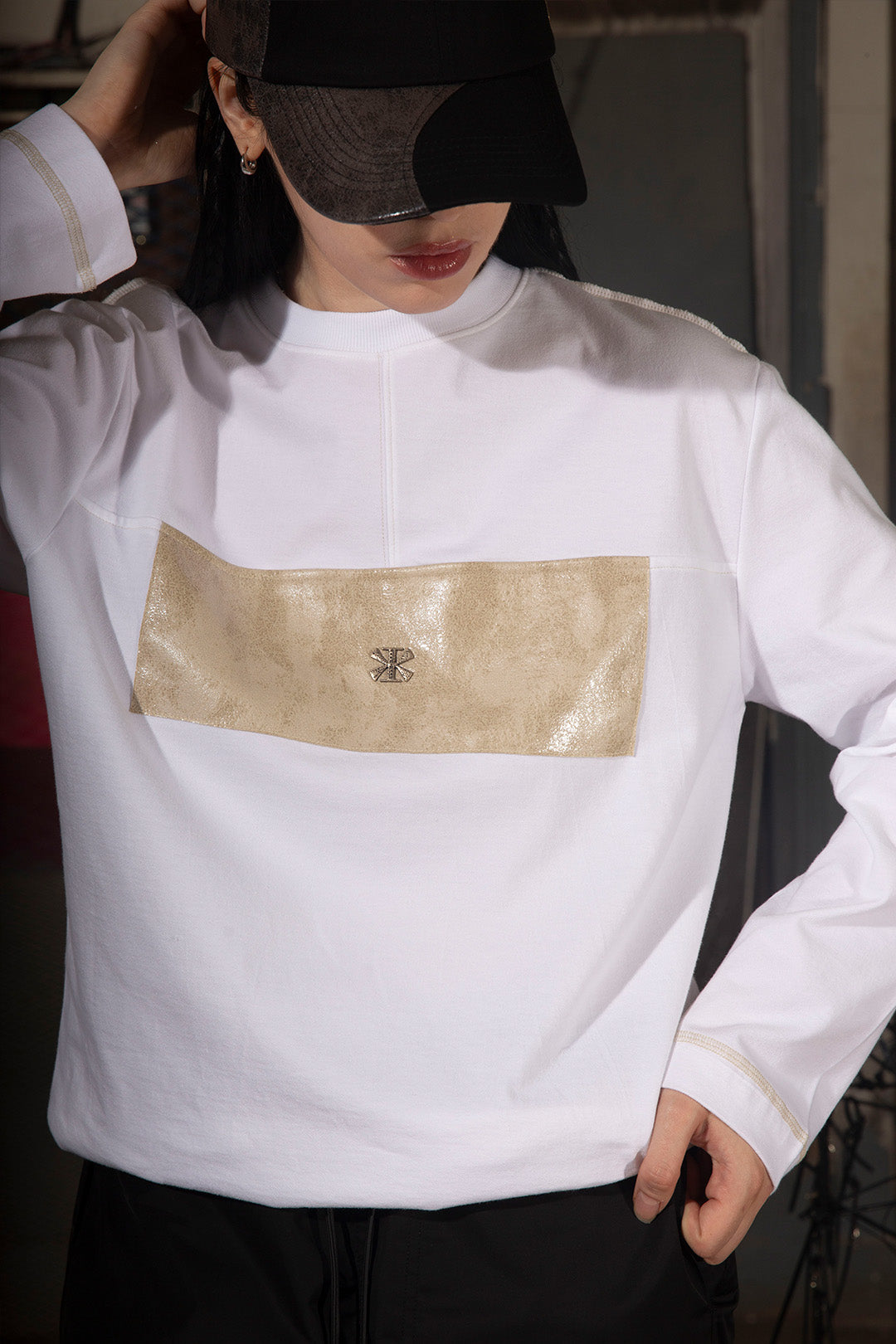 KIMMICK creviced patchwork long sleeve white cap with textured fabric and unique design, displayed in close-up.