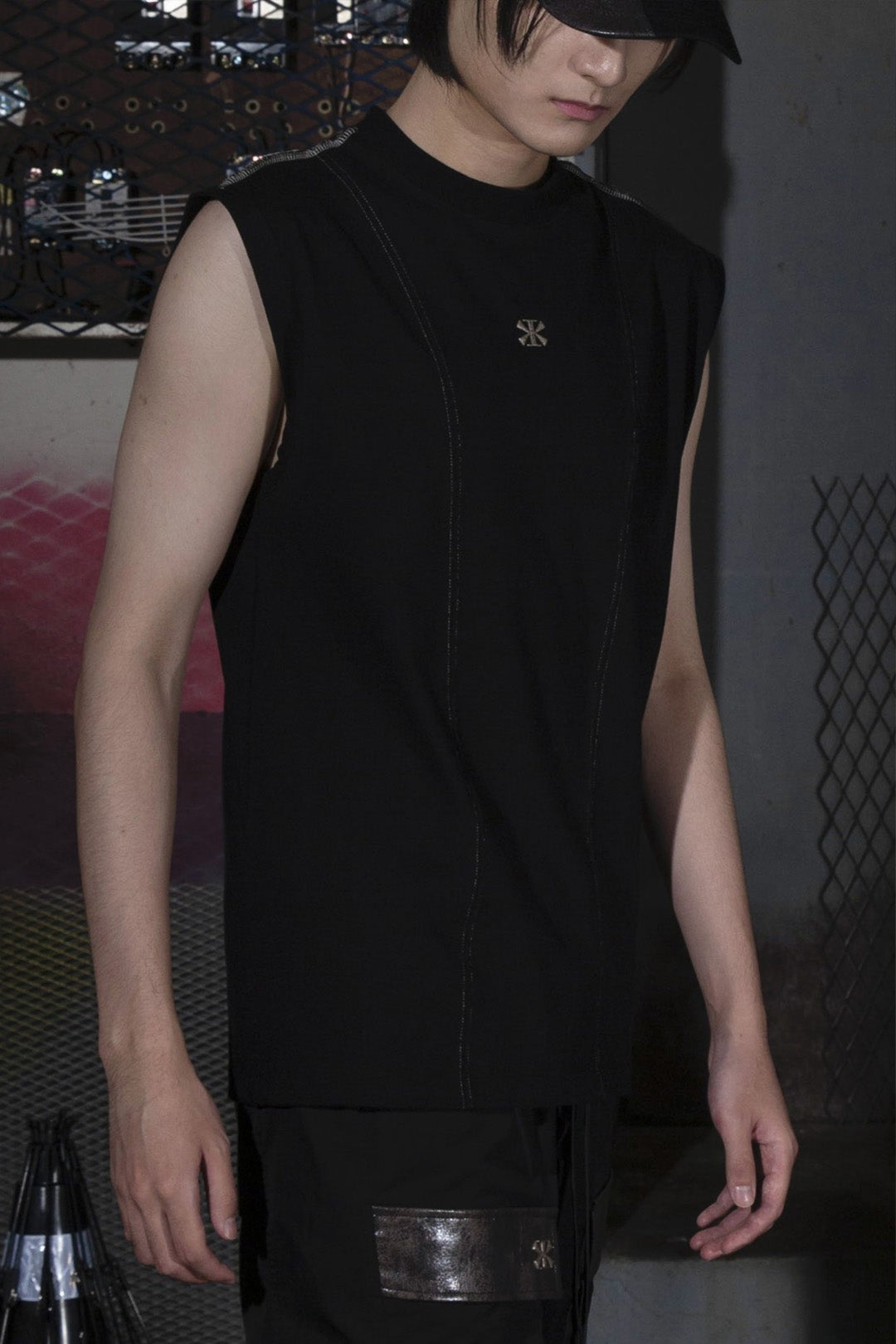Black creviced stealth-stitched sleeveless top by KIMMICK, showcasing its textured fabric and sleek sleeveless design.