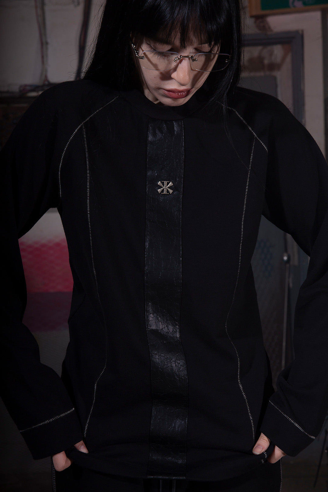 Close-up of KIMMICK Creviced Bite Raglan half sleeve black top showing textured fabric and relaxed fit.