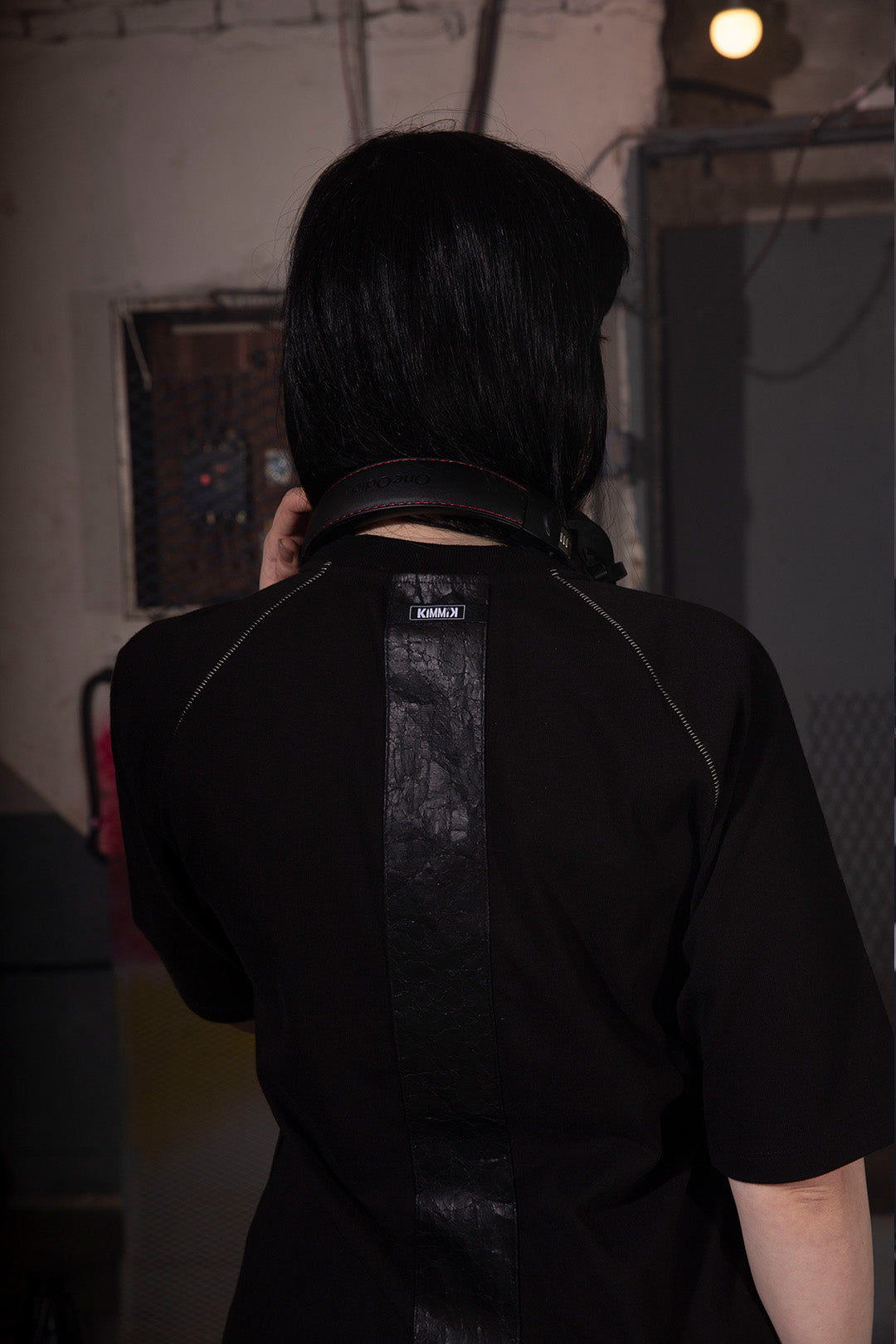 Close-up of KIMMICK Creviced Bite Raglan Black short sleeve top showing textured fabric and relaxed fit.